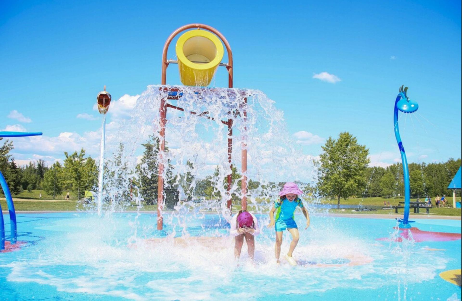 Children having fun at the splash park on a sunny day.
