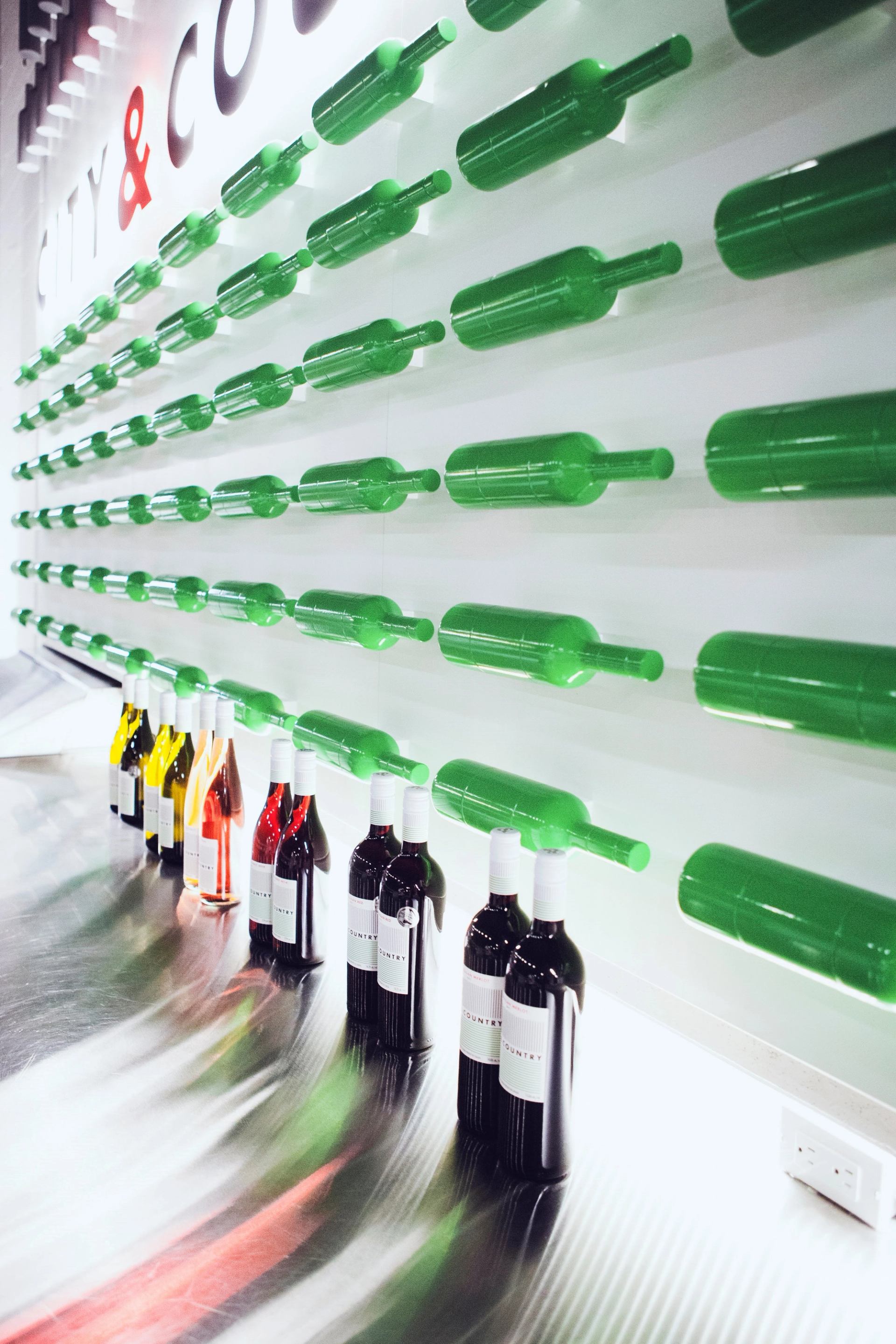 Wall display of wine bottles at City & Country Urban Winery.