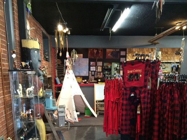 A store display featuring a red and black plaid shirt, playful trapdoor underwear, and a tipi play area for children.