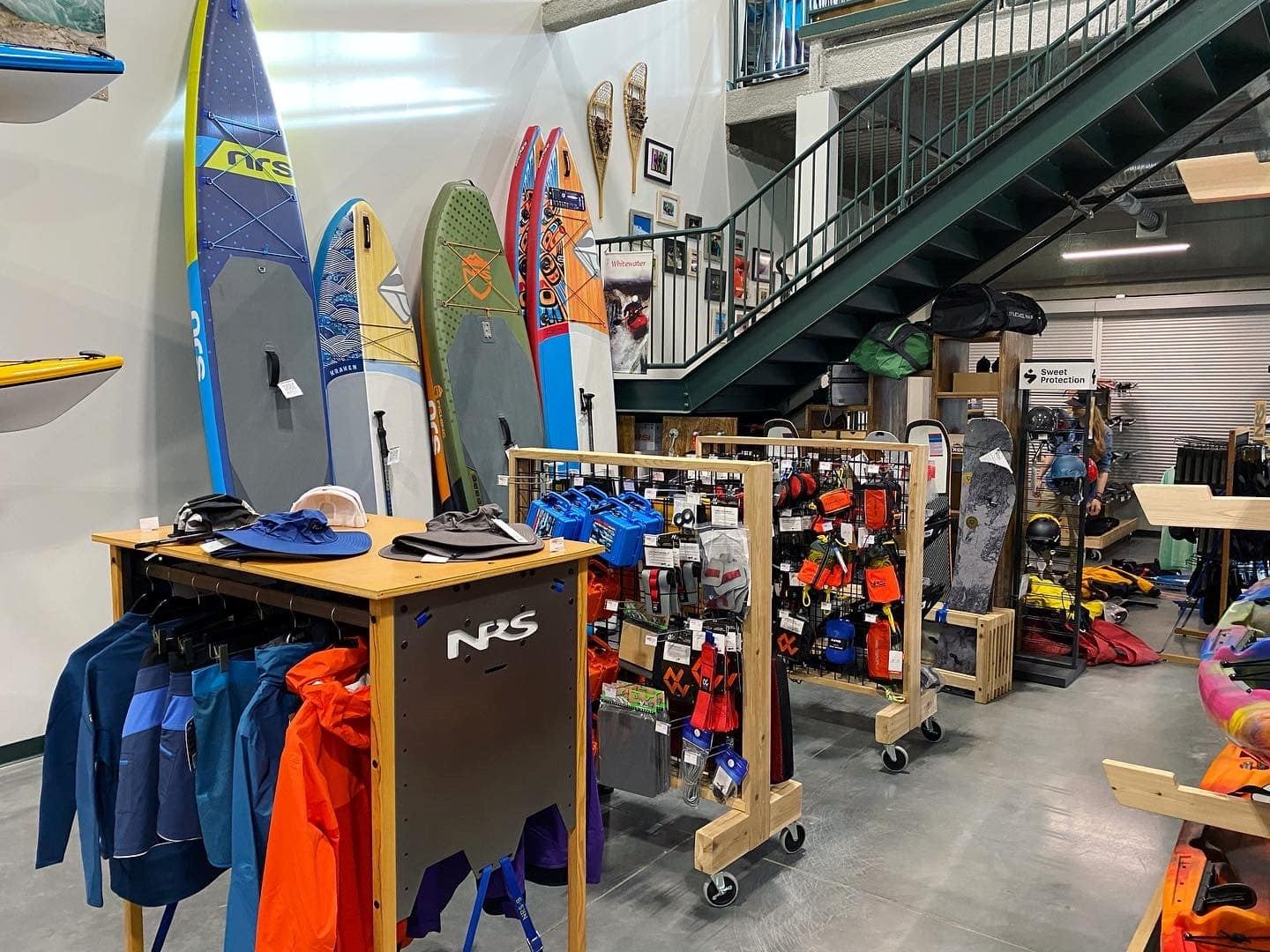 Paddleboards and gear displayed in Aquabatics Calgary’s water sports retail store.