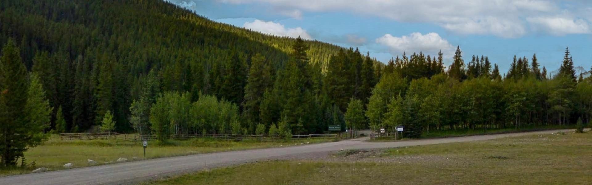 Campground entrance at Dutch Creek surrounded by forest and foothills