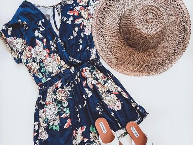 Floral dress, straw hat, and leather sandals displayed on a white background.