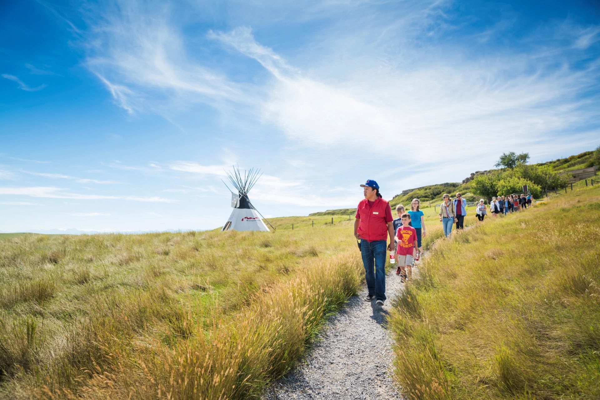 Group walking the pathways at Head-Smashed-In Buffalo Jump with an Indigenous guide.