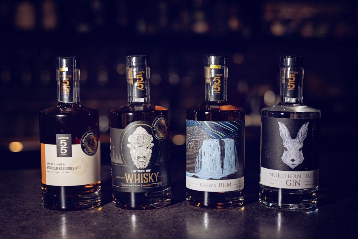 Interior of Latitude 55 Distillery & Lounge with craft cocktails on the table.