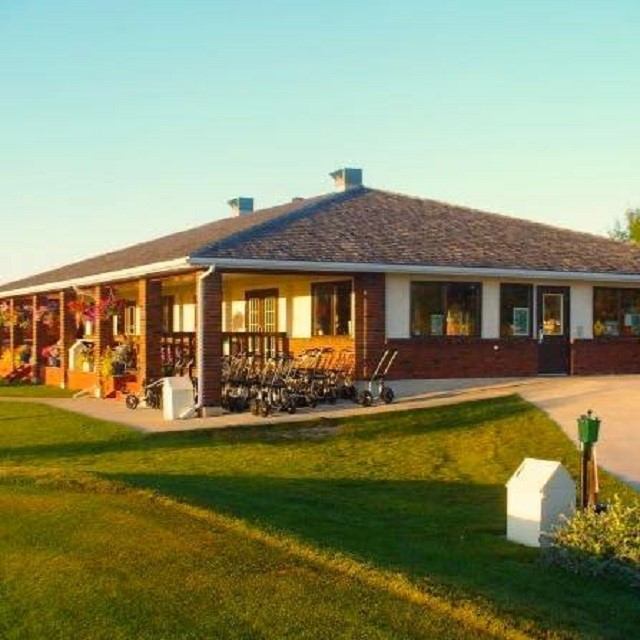Clubhouse with flower baskets and golf carts at Gull Lake Golf Course.