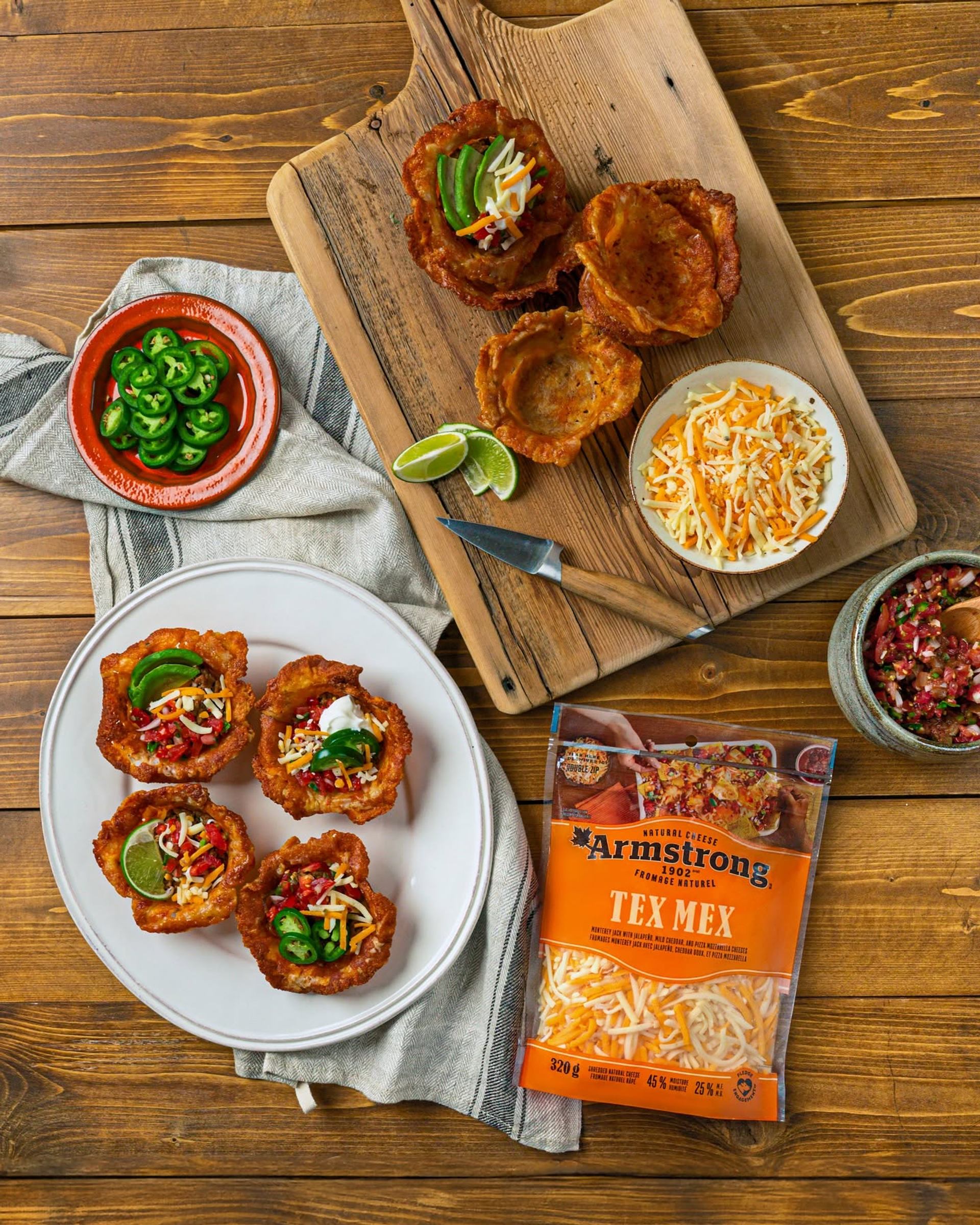 Tex Mex cheese package beside plated taco cups with jalapeños, lime wedges and salsa.