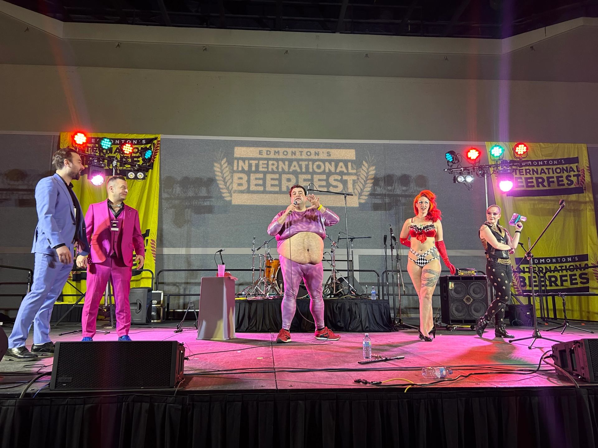 Performers in colourful outfits stand on stage at Edmonton’s International Beerfest event.