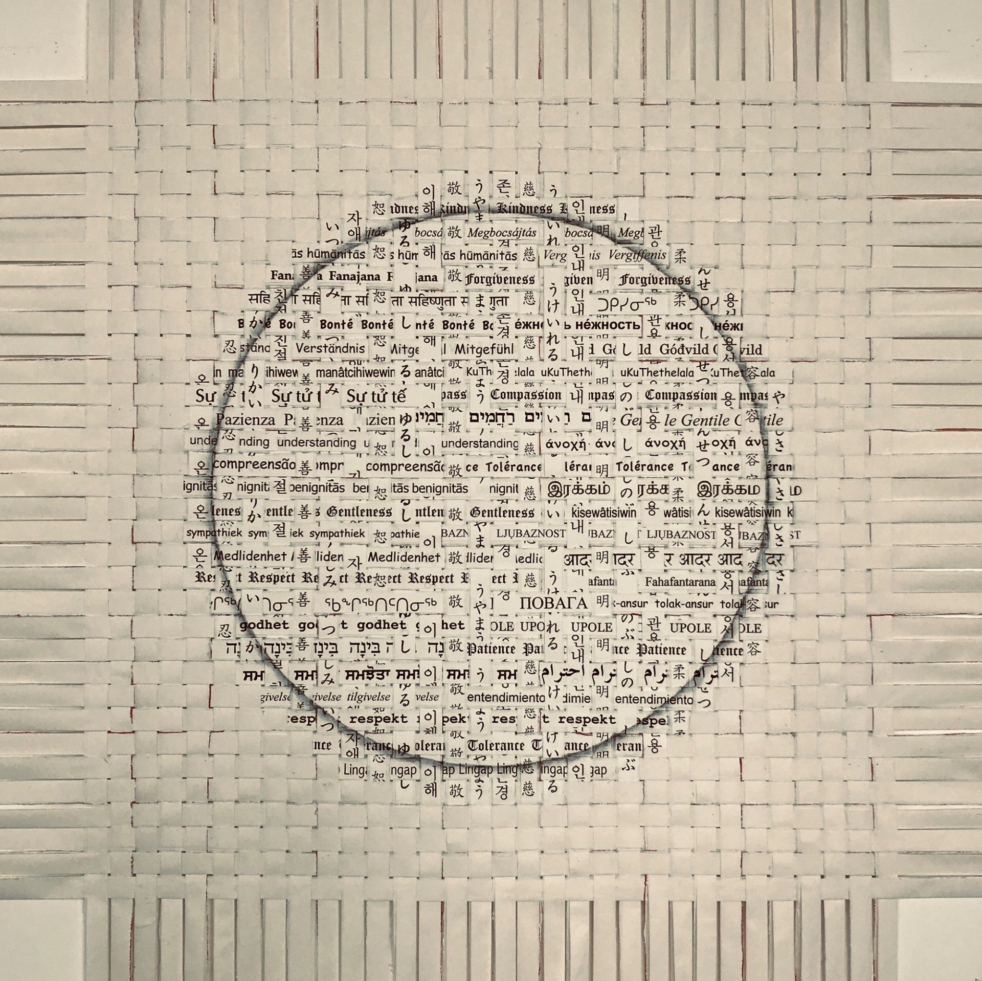 Artwork featuring a circular area filled with dense text, surrounded by a grid-like pattern on paper.