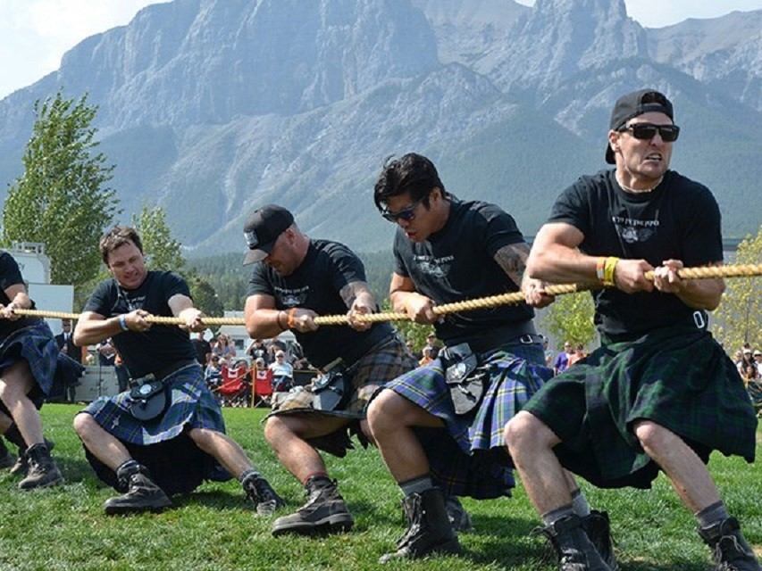 A group of men participating in tug-o-war.