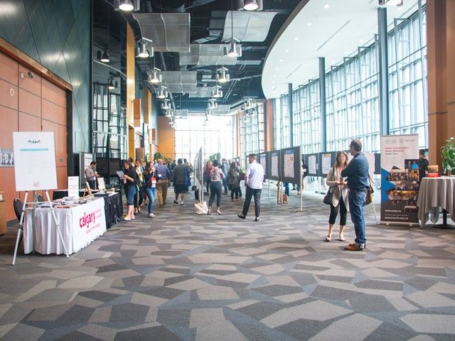 People gathering in a bright, airy meeting space in the Convention Centre.