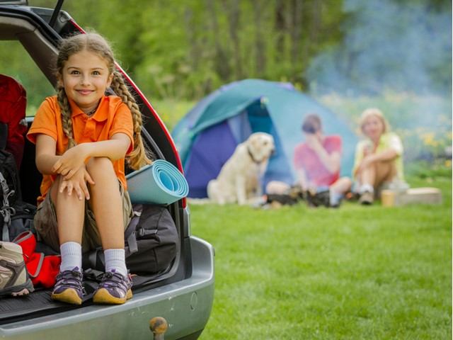People enjoying a sunny campsite with a car, tent, and picnic chairs at Millet Lions Memorial Campground.