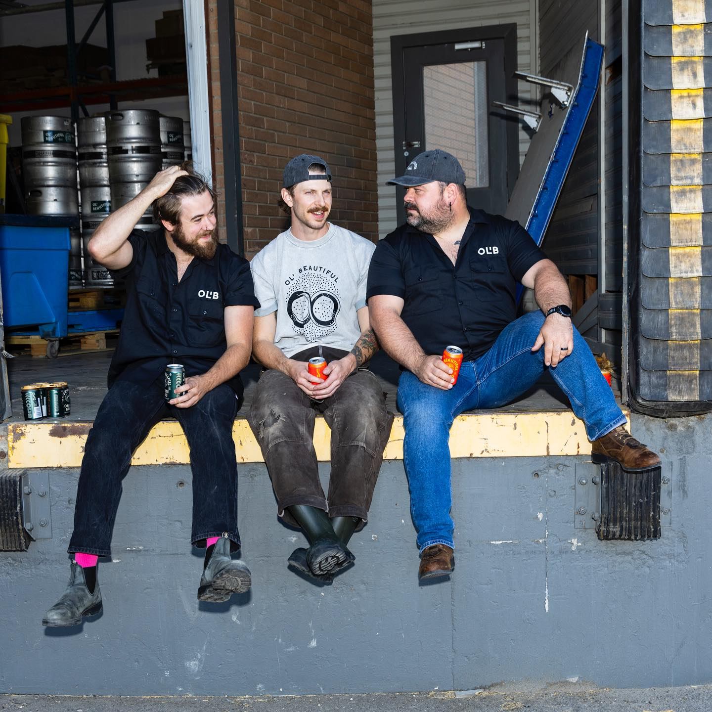 Three men modeling Ol' Beautiful merchandise.