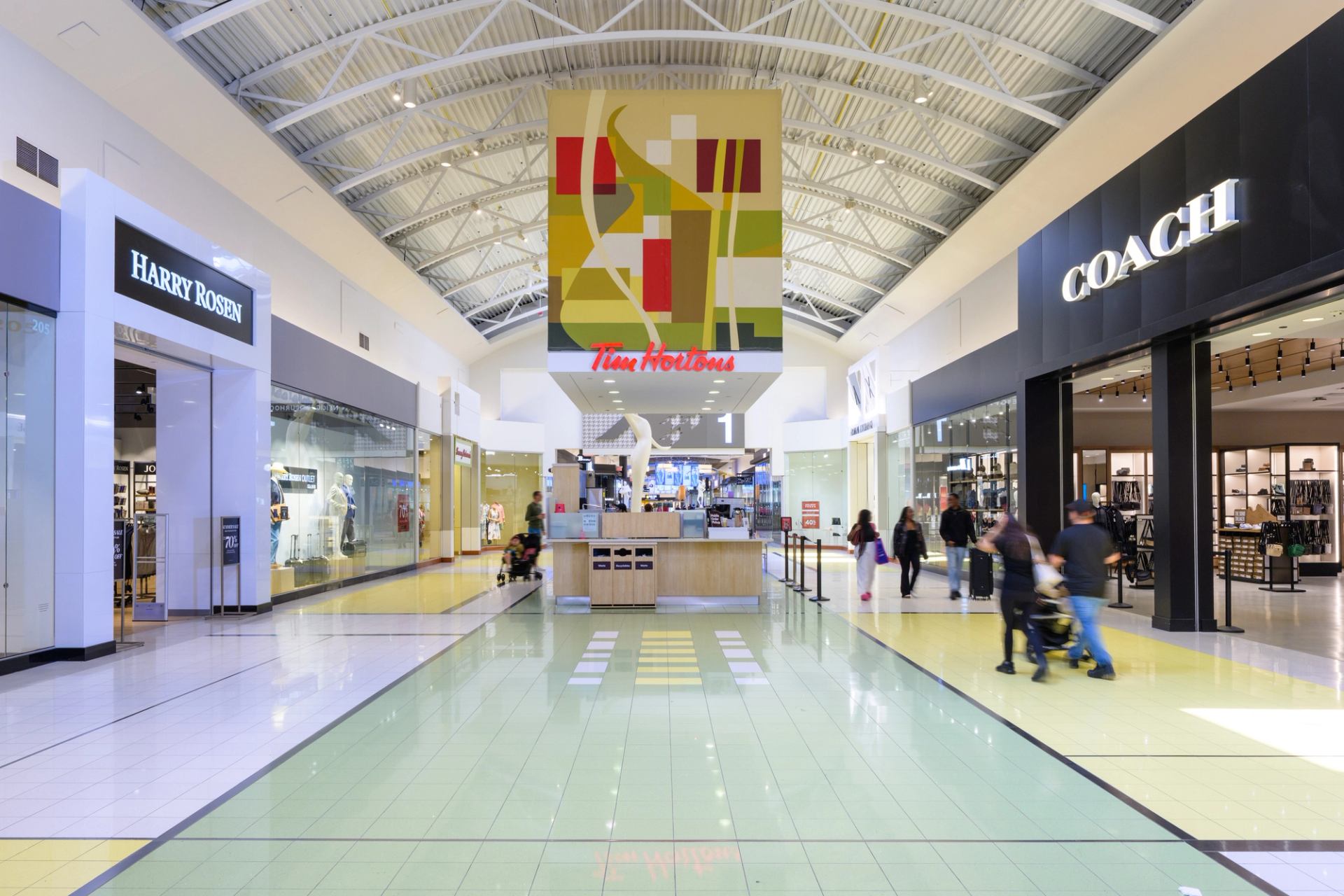 Mall corridor with Coach, Banana Republic, and Tim Hortons under skylights.