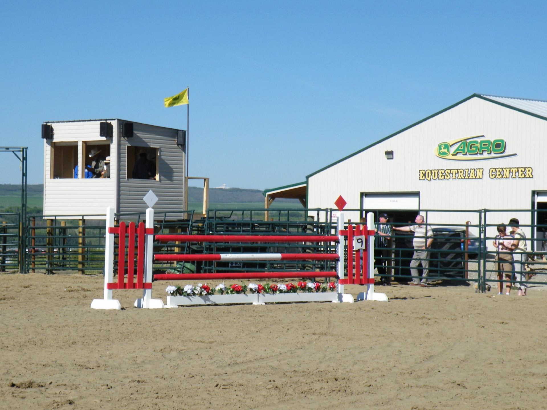 Alt Text: Red-and-white jump setup outside CABRO Equestrian Center