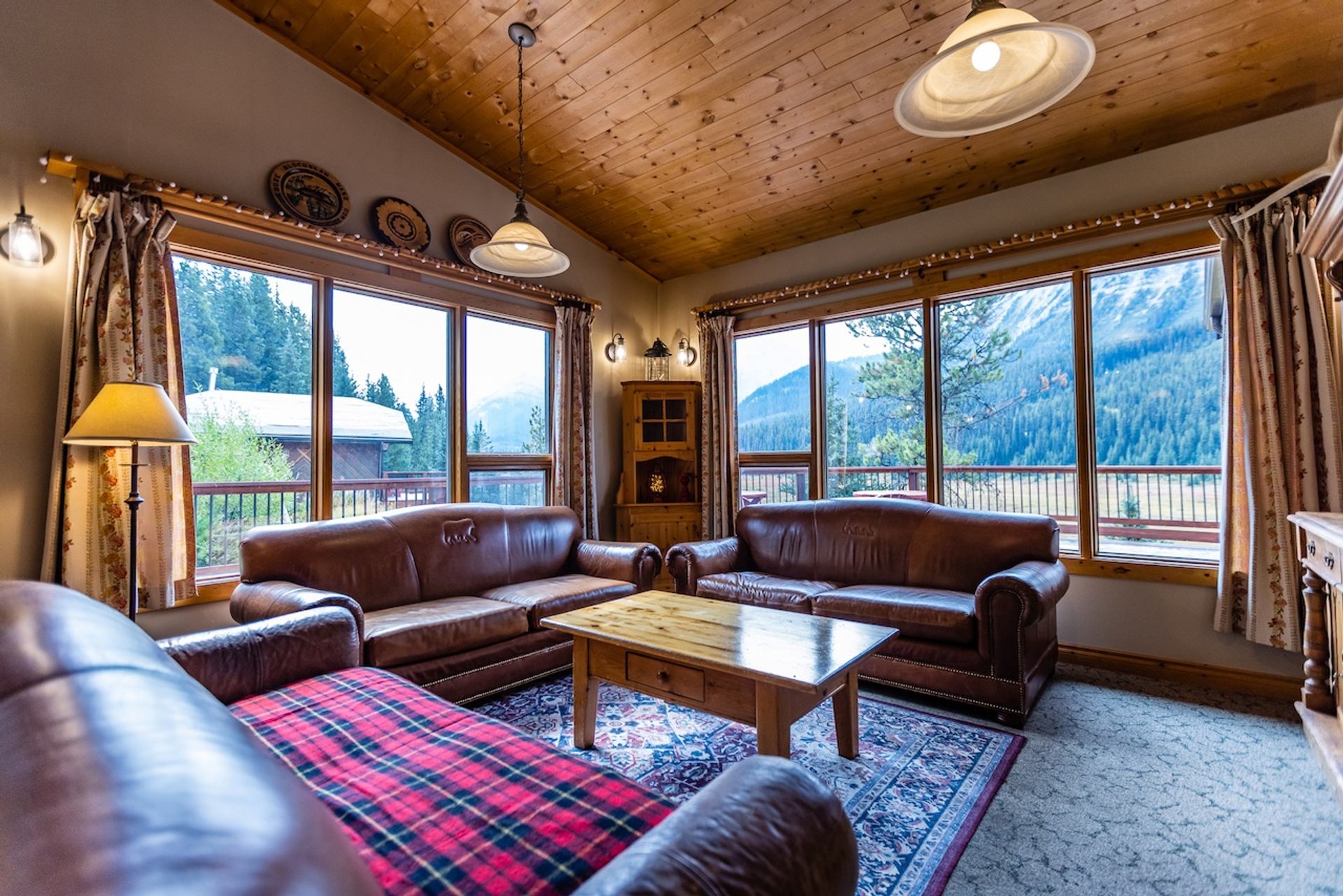 Cozy lounge with leather sofas and large windows overlooking mountains