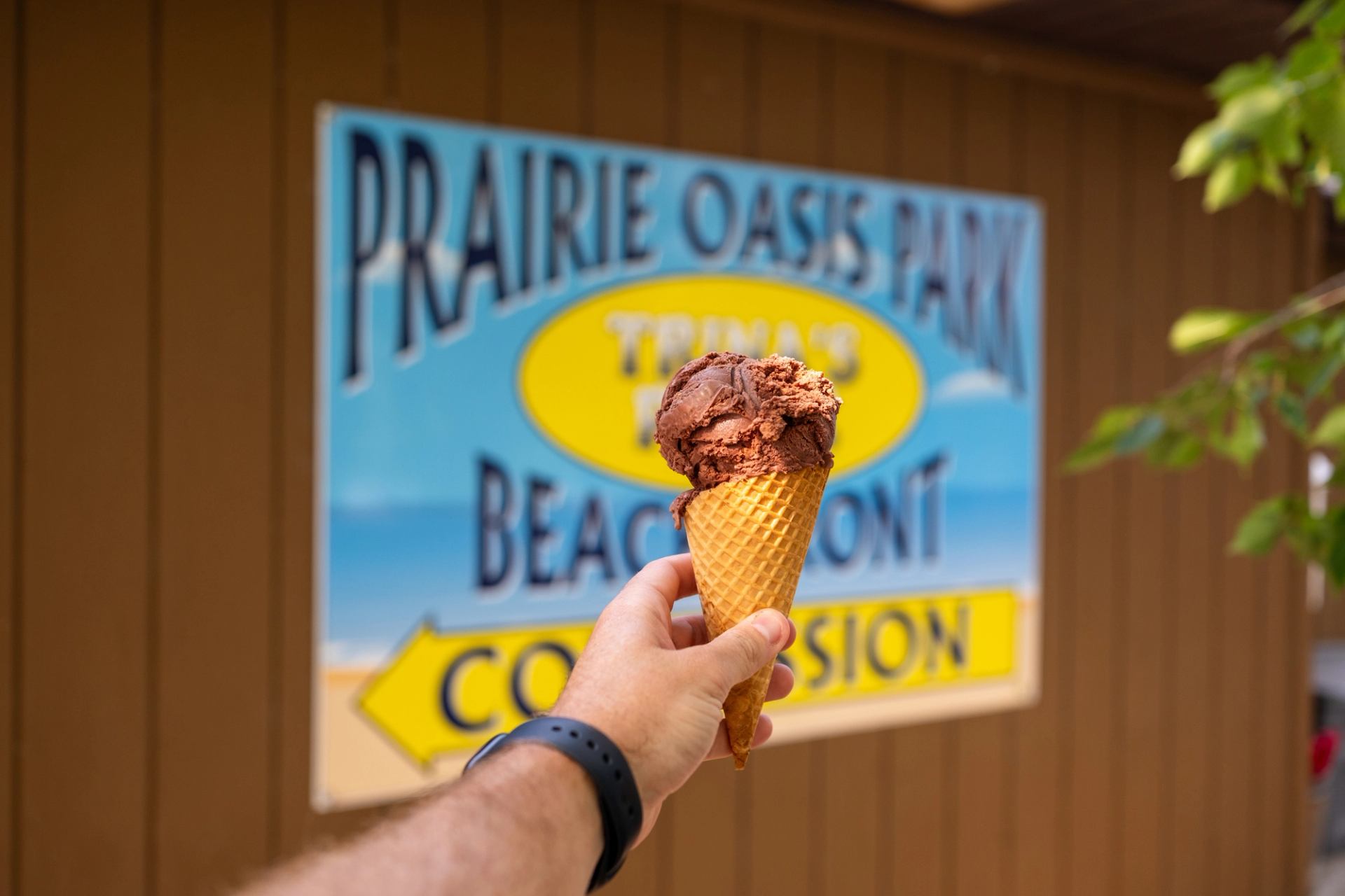 A person holding an ice cream at Prairie Oasis Park.