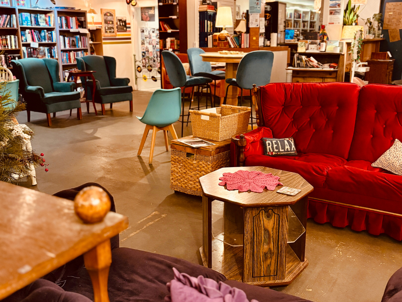 inside Found Books & Shop with living room vibes - lots of comfy seating, walls lined in book shelve