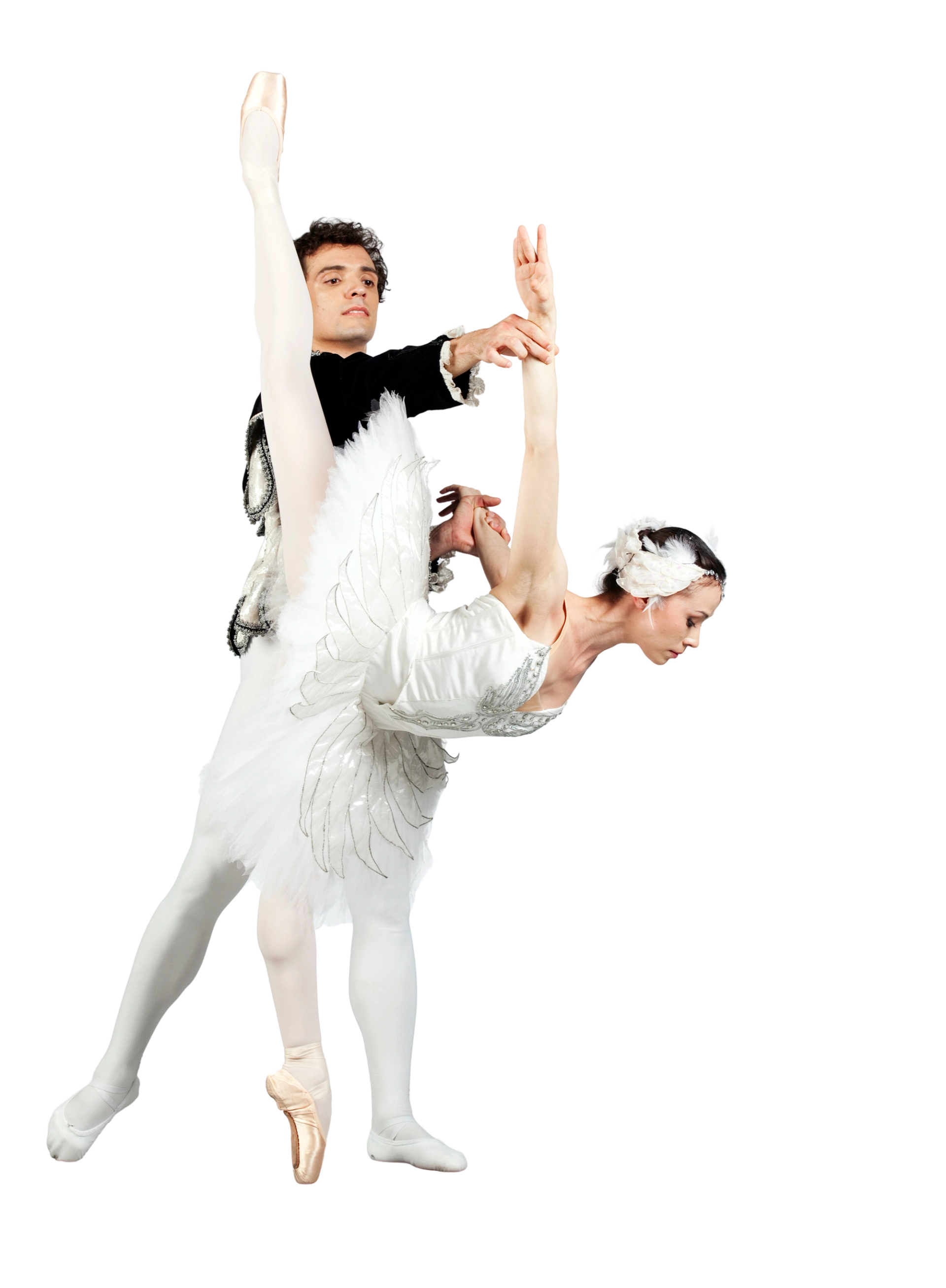 Ballet dancers in white costumes perform a partnered lift against a plain background.