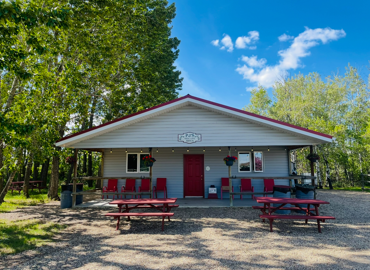 Exterior of the event centre with picnic tables and chairs