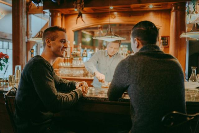 Two men having a drink at the bar in Buffalo Mountain Lodge