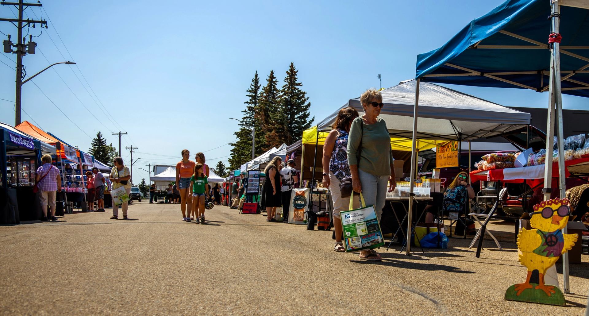 People visiting the vendors at the market.