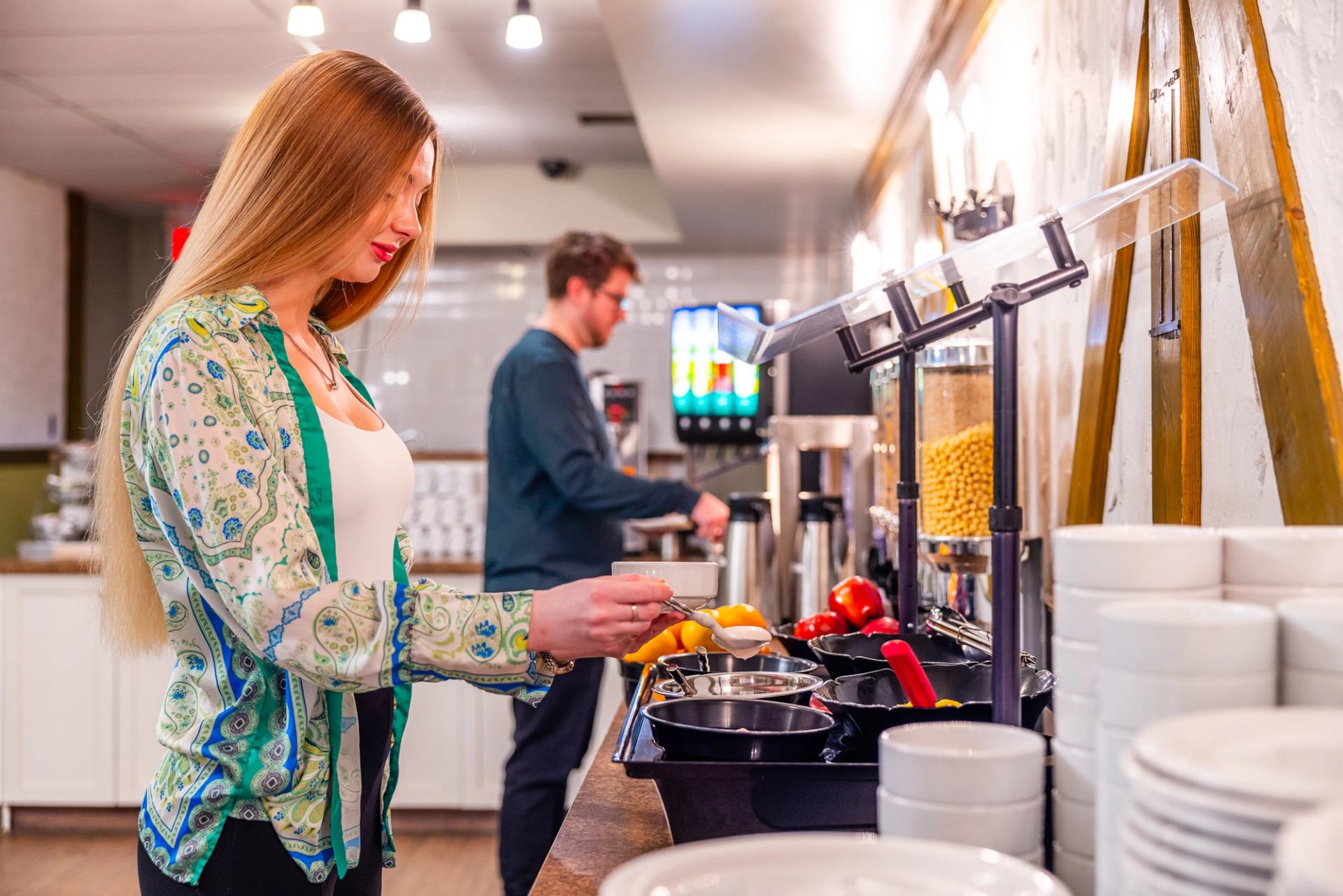 Guest enjoying the Mountaineer Lodge breakfast buffet, offering hearty morning options before explor