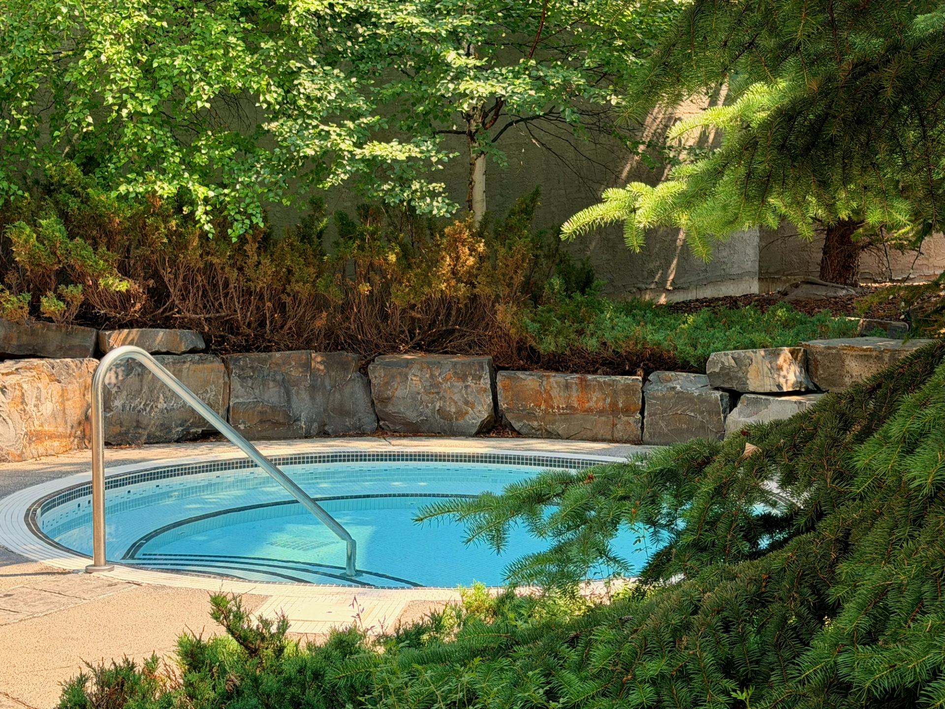 One of two peaceful outdoor hot pools on a sunny Canmore day at Bodhi Wellness