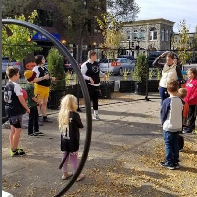 Group of people gathered in a circle outdoors.