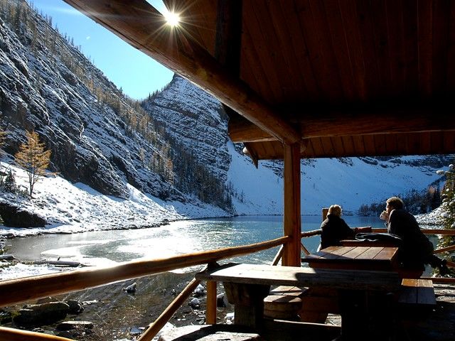 Couple enjoying a beverage while taking in the sights from Lake Agnes Tea House.