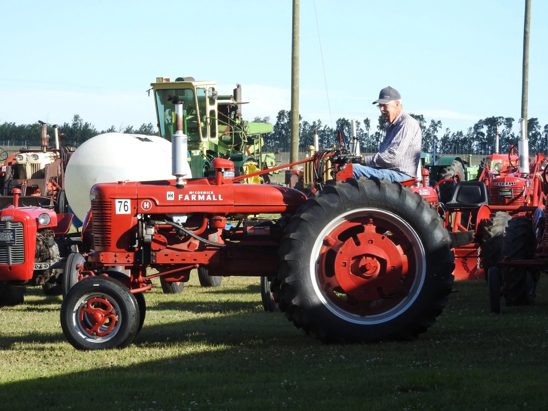 Tractor display at South Peace Centennial Museum Association, with large tires and operator cabin.