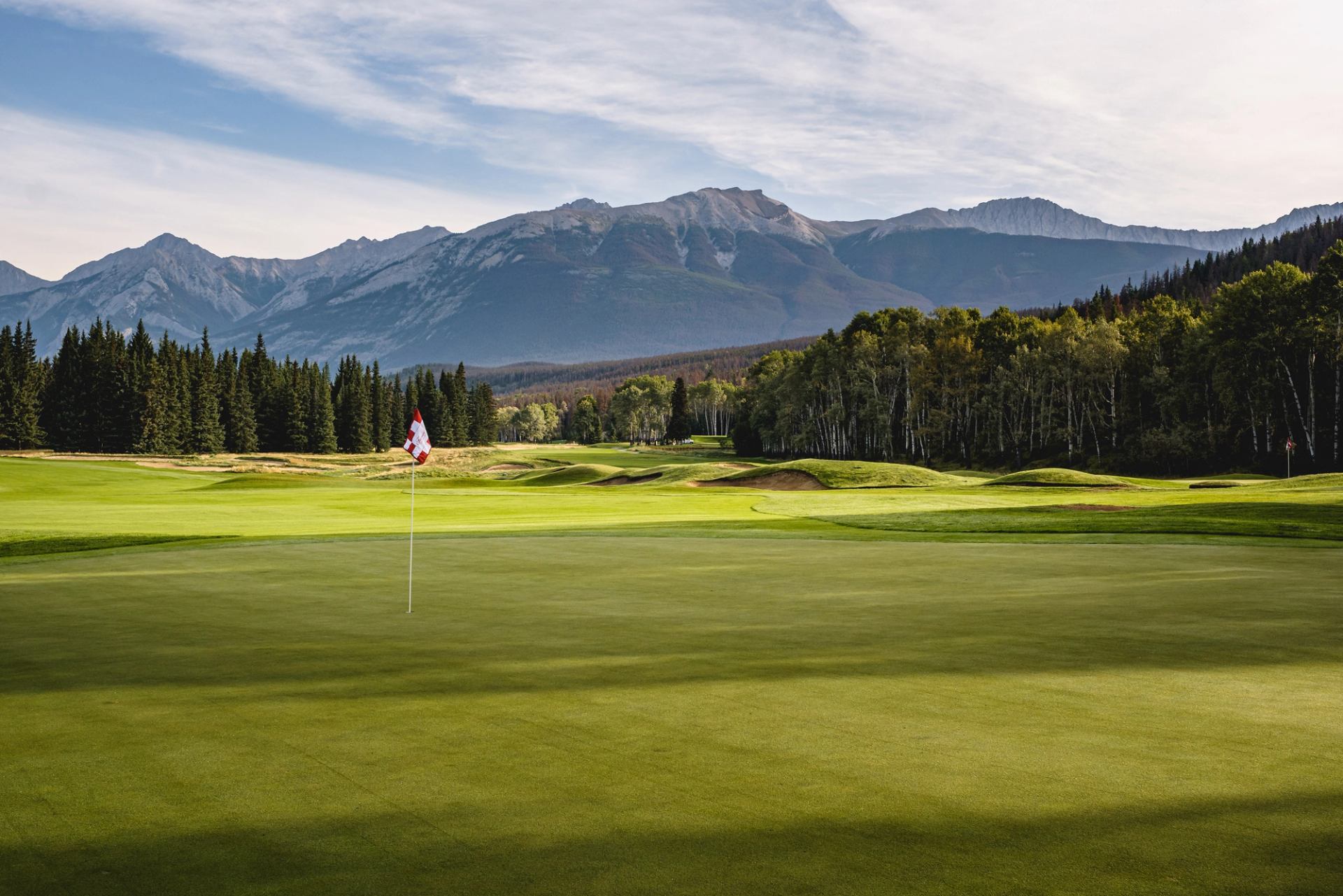 Scenic photo of a hole and flag at Fairmont Jasper Park Lodge Golf Course