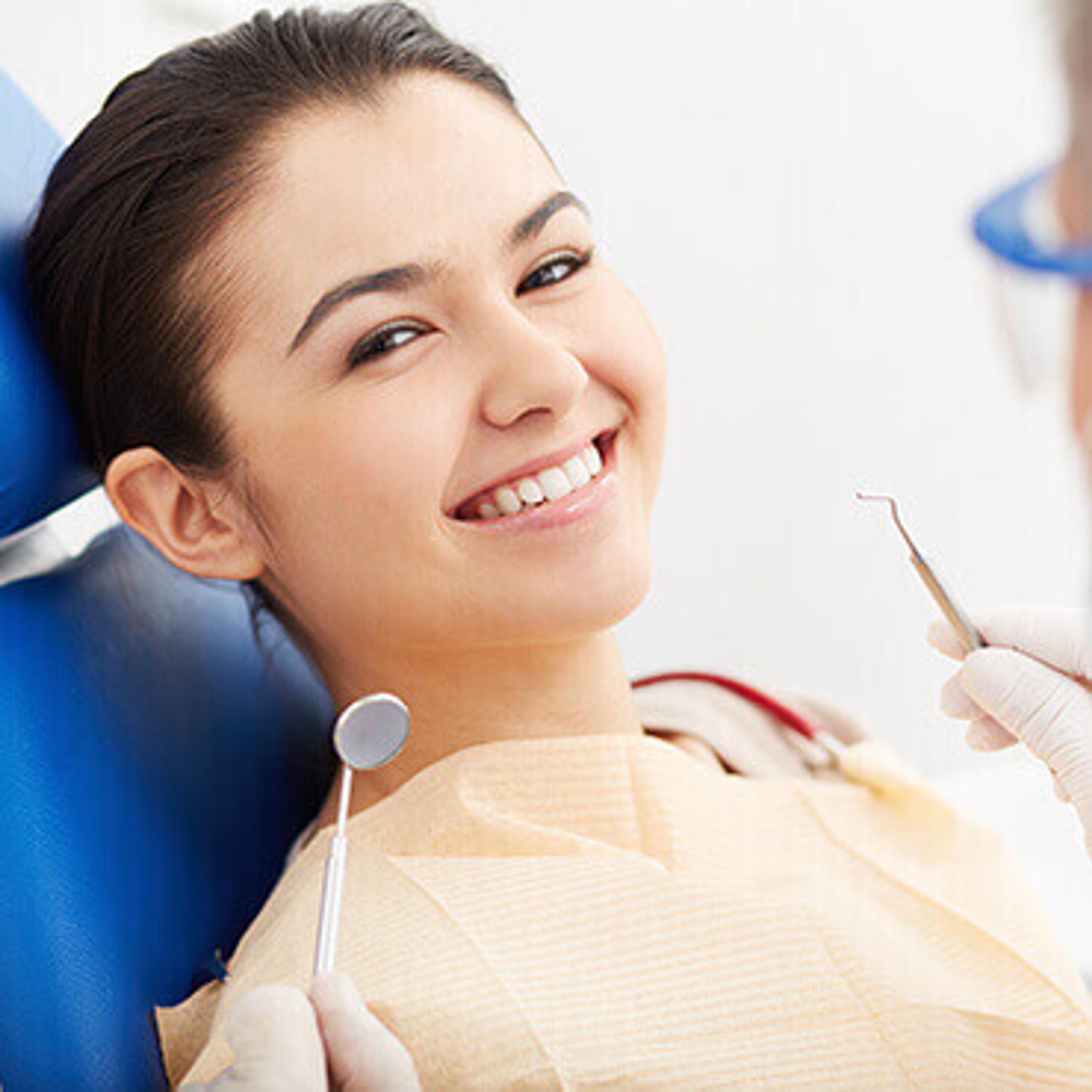 Patient in the dental chair smiling at the dentist