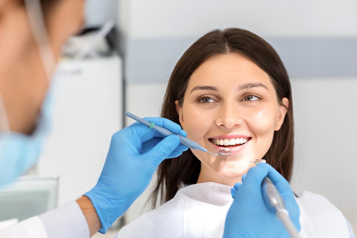 A patient smiling during an exam at Lord Dufferin Dental