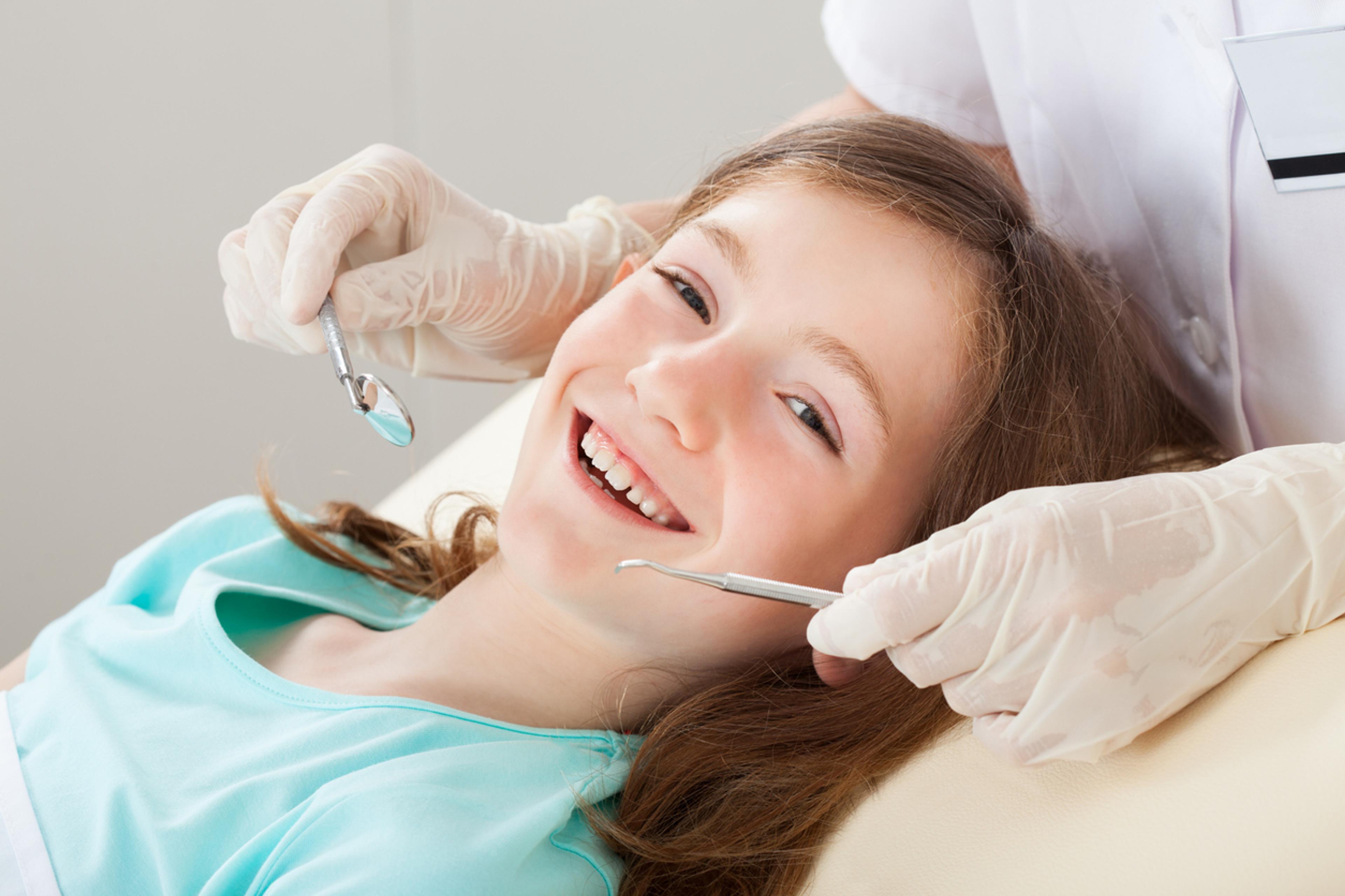 Child smiling in a dental chair