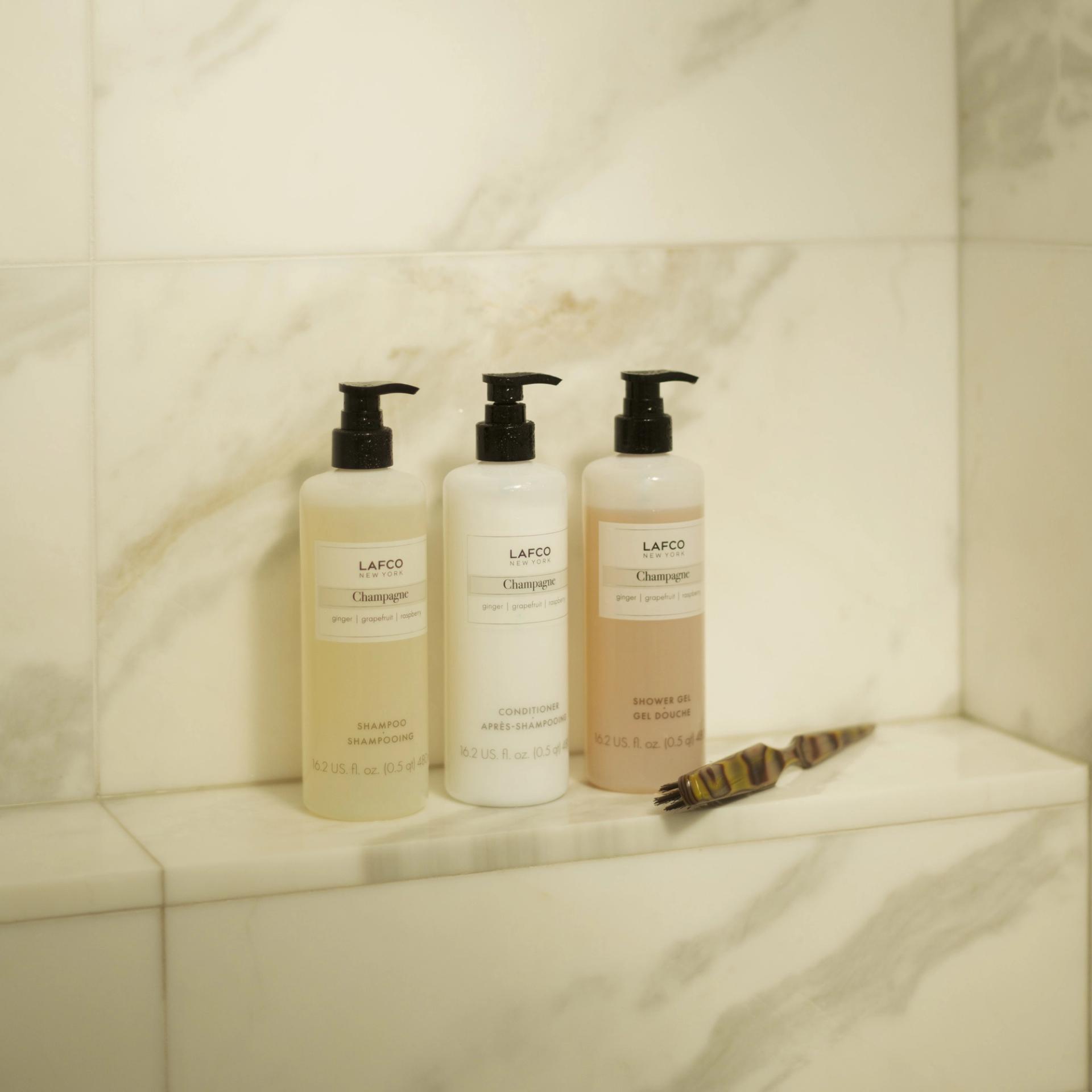 Lafco Champagne Shampoo, Conditioner and Shower Gel on shower ledge