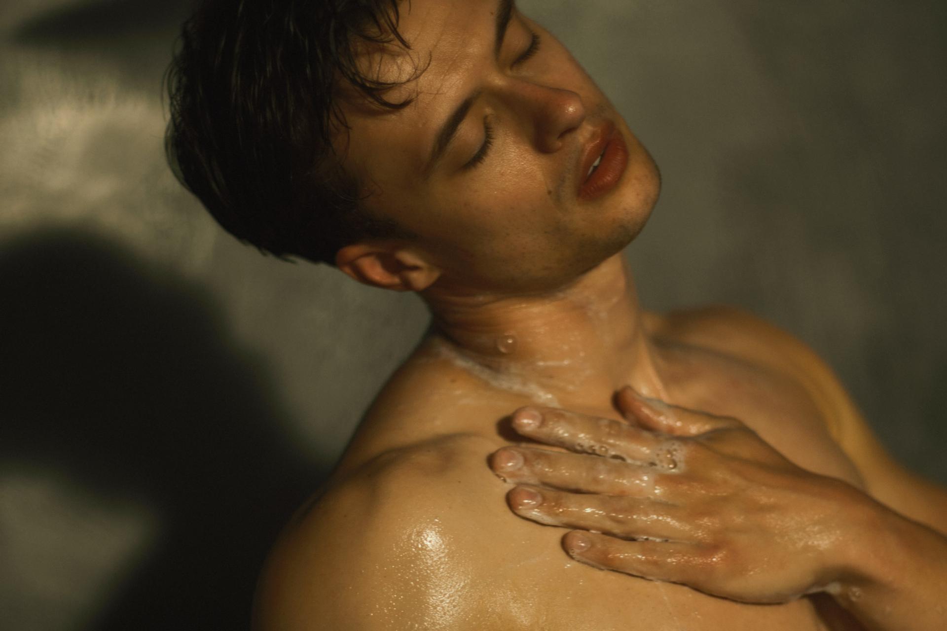 Guy lathering in shower