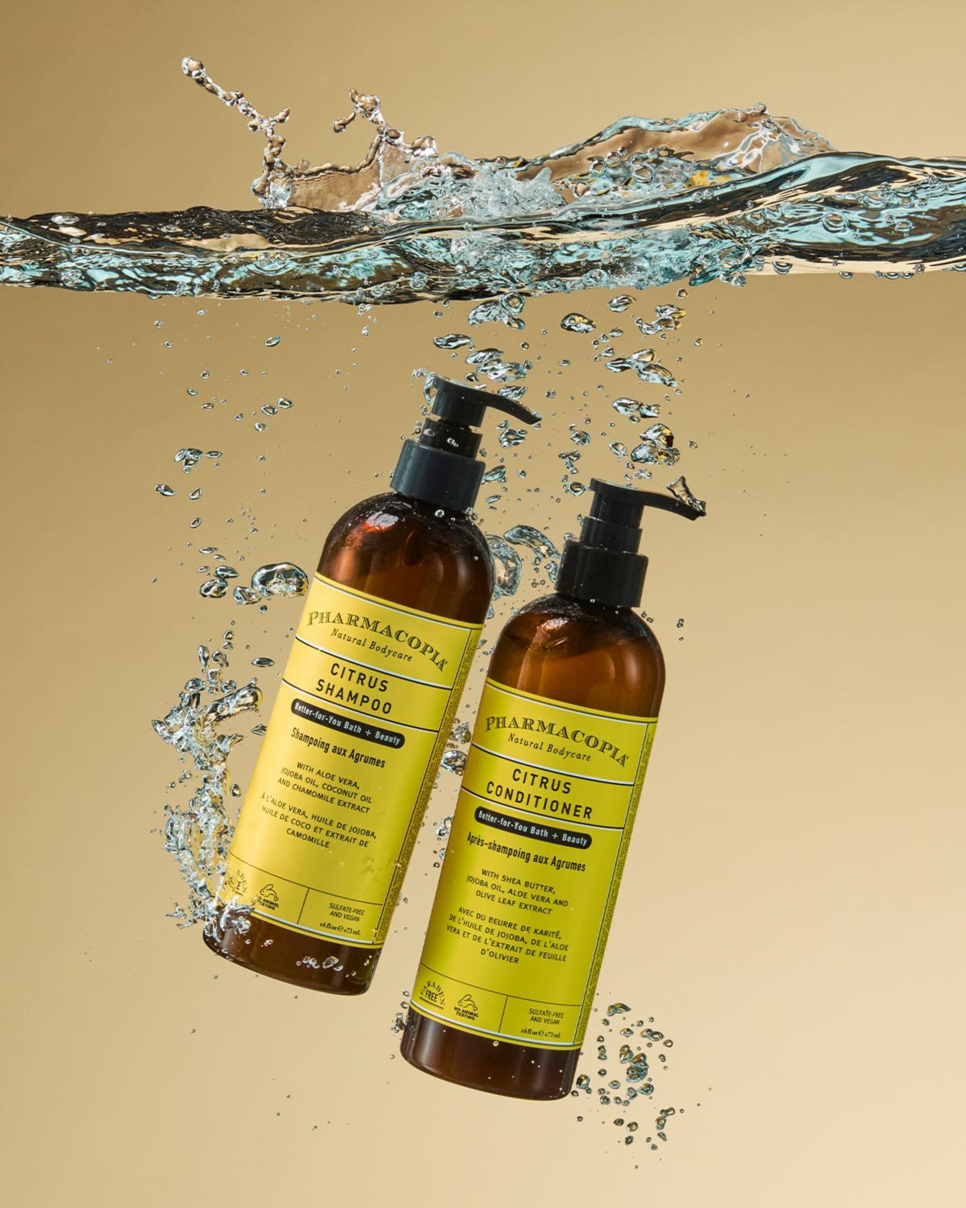 Pharmacopia Citrus Shampoo and Conditioner dispensers in water