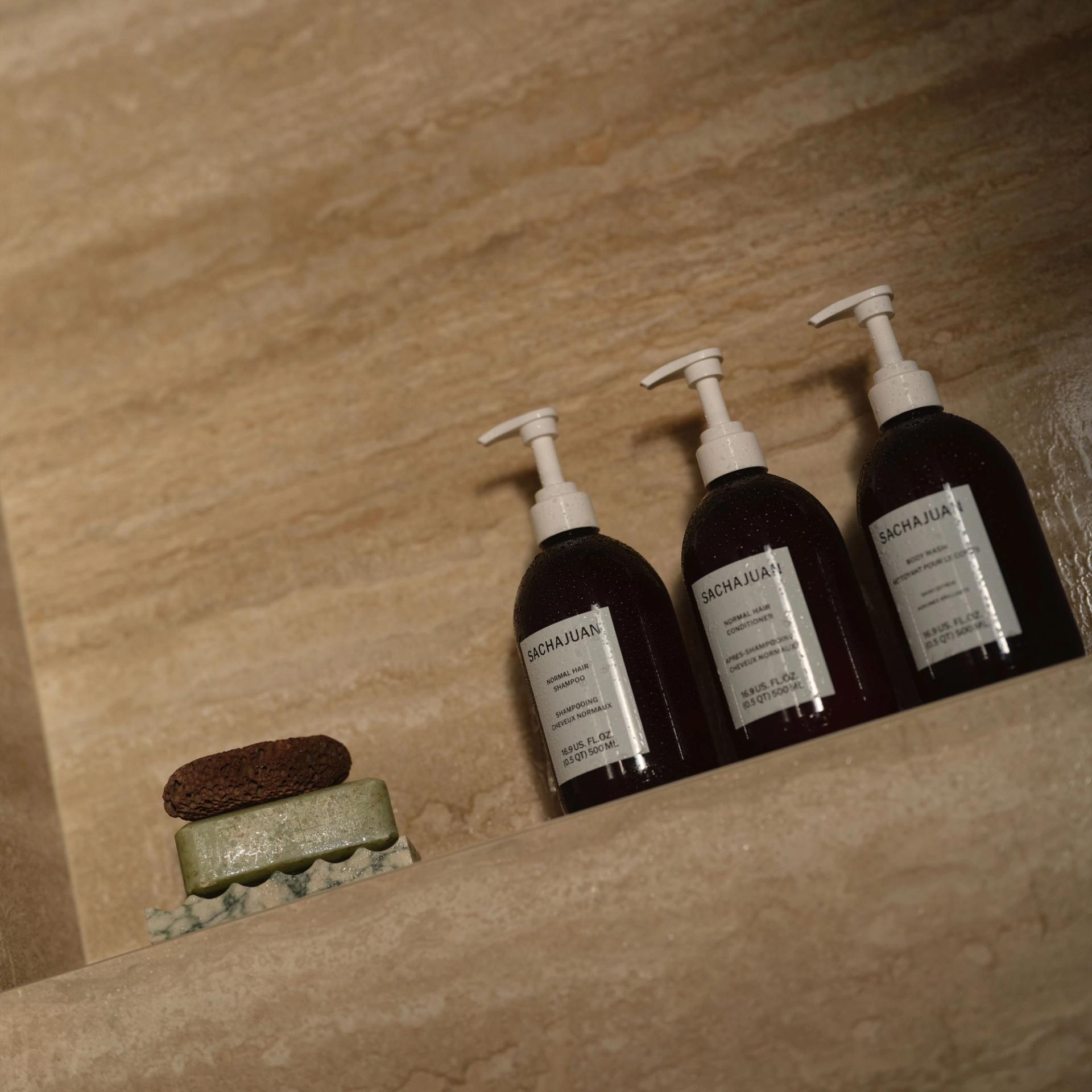 Frama Shampoo, Conditioner, Body Wash in the shower.