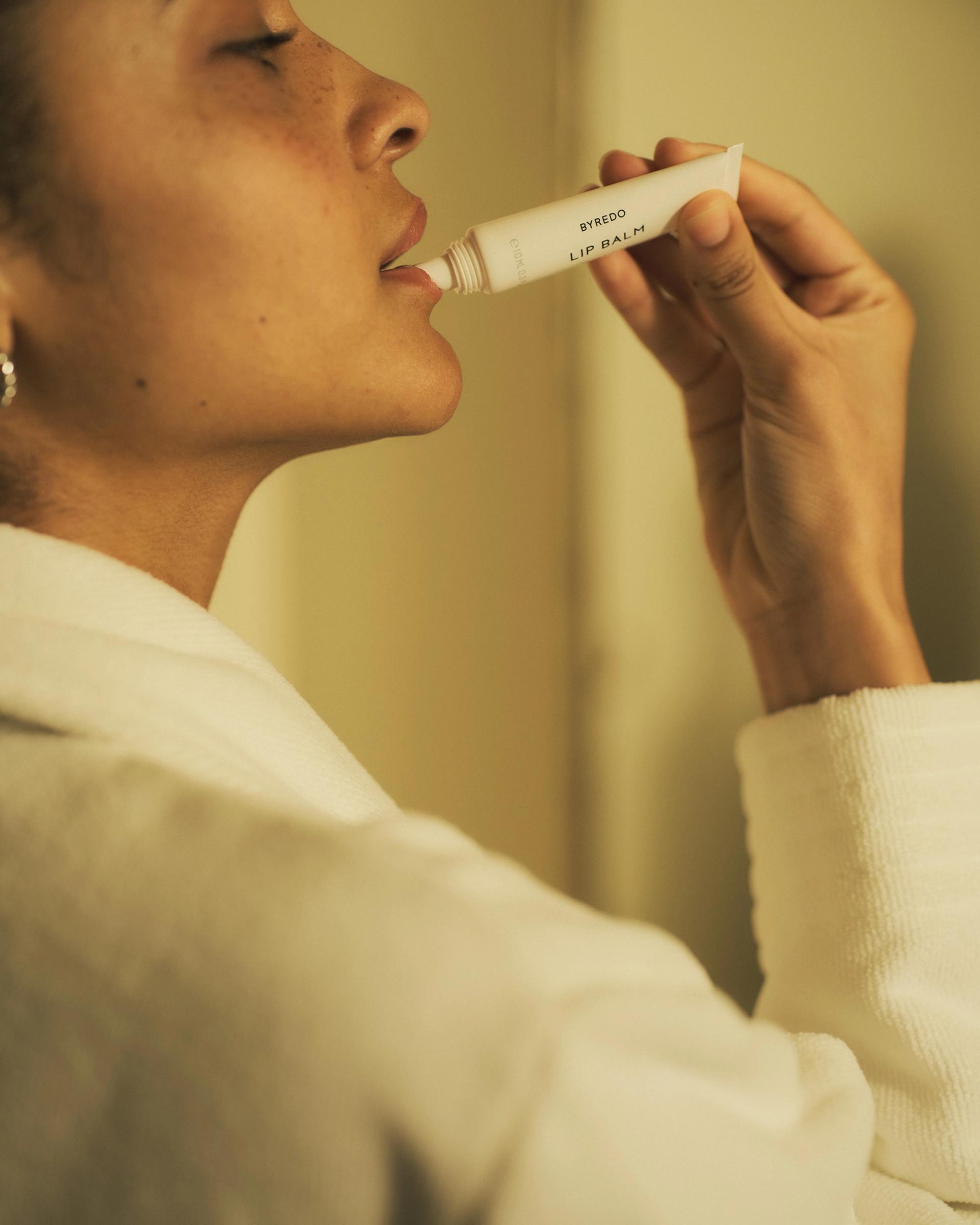 Girl applying Byredo Lip Balm