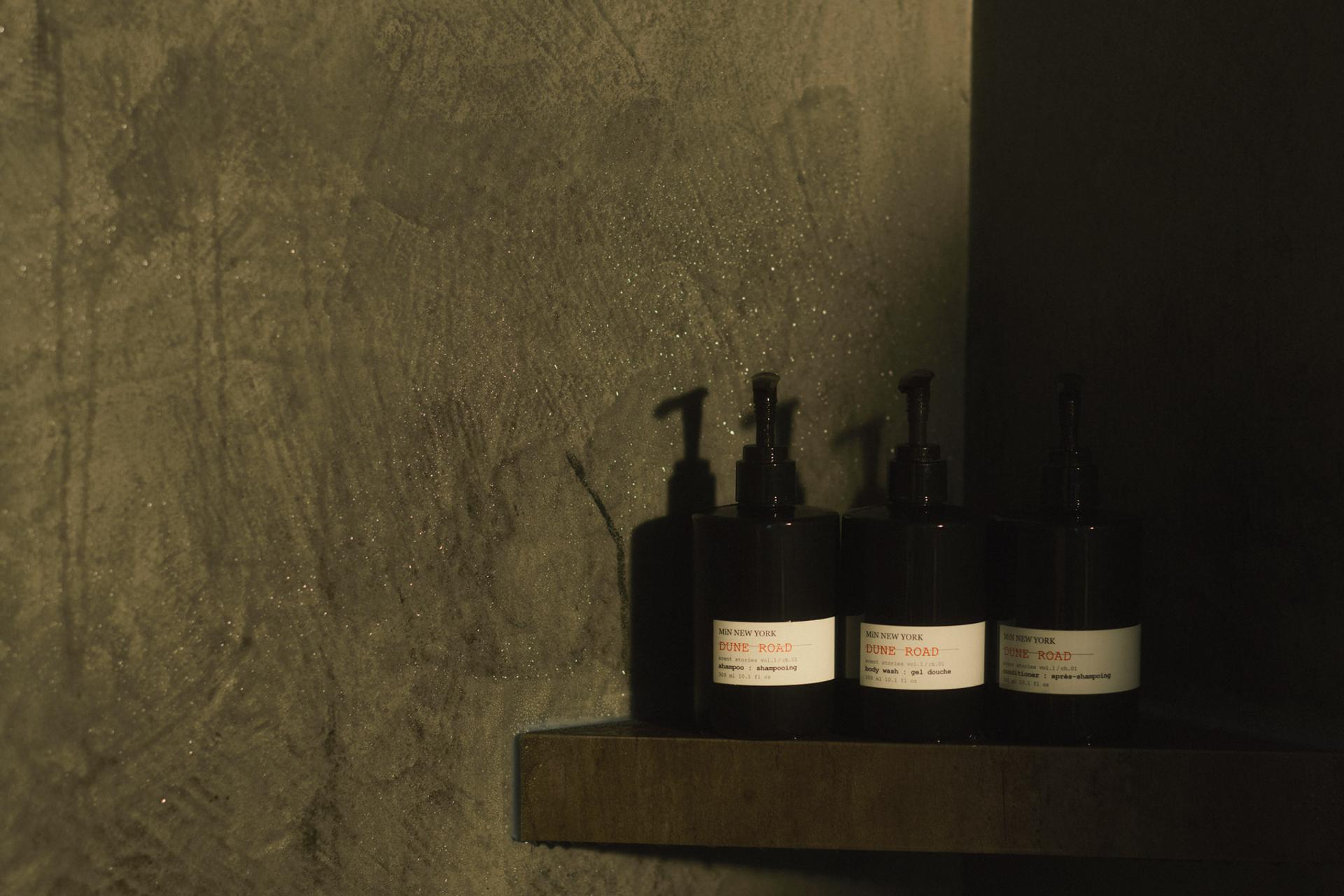 MiN New York Dune Road Shampoo, Conditioner and Body Wash dispensers on shower shelf