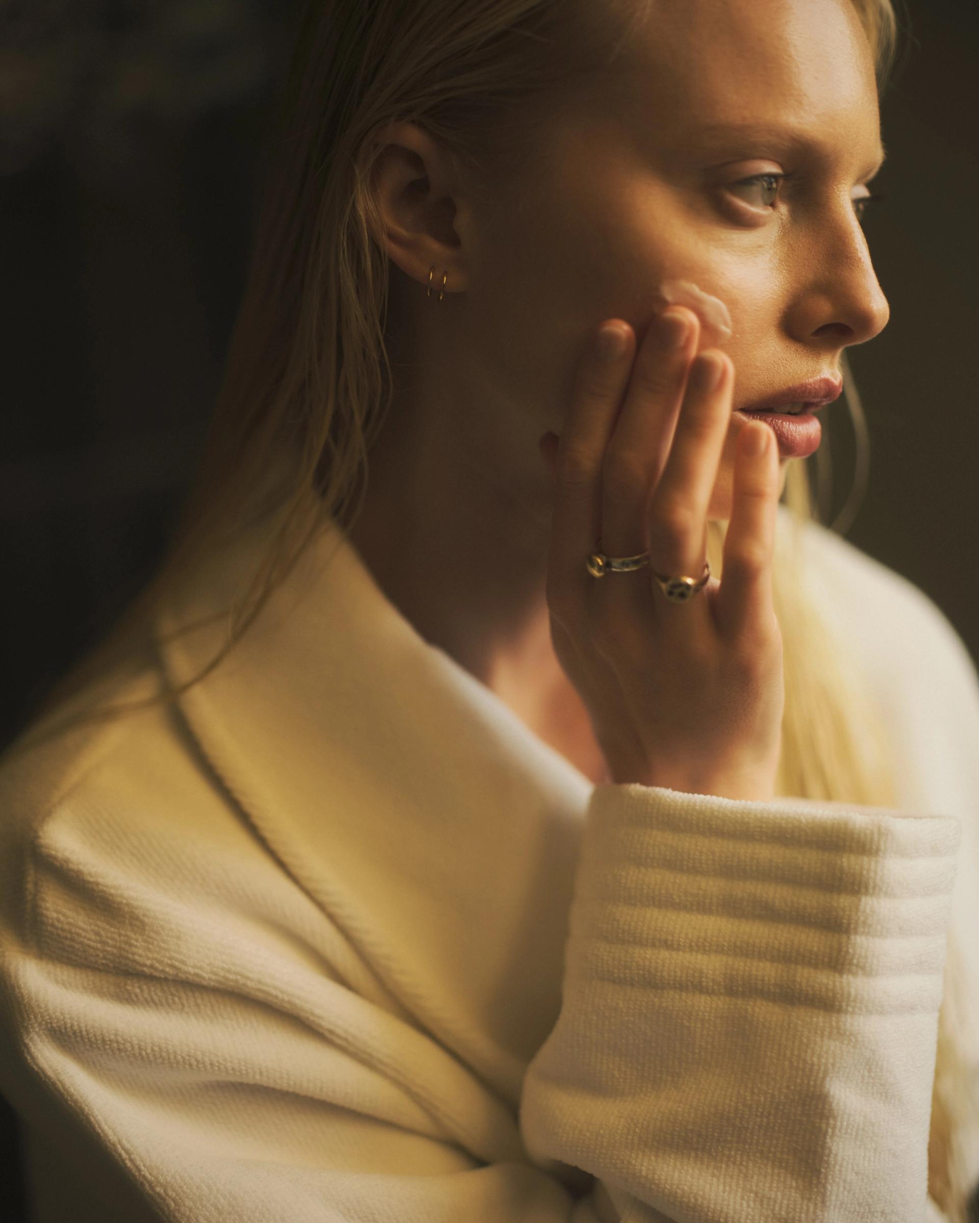 Girl applying face cream