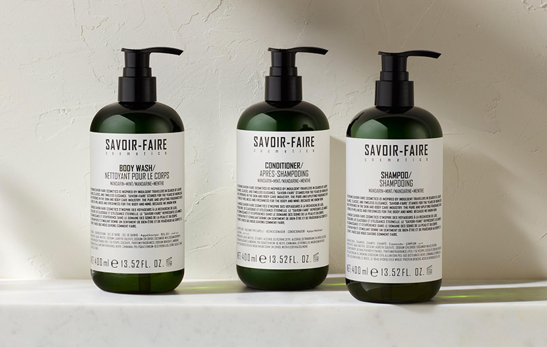 Savoir-Faire Mandarin Mint Shampoo, Conditioner, and Body Wash dispensers on shelf