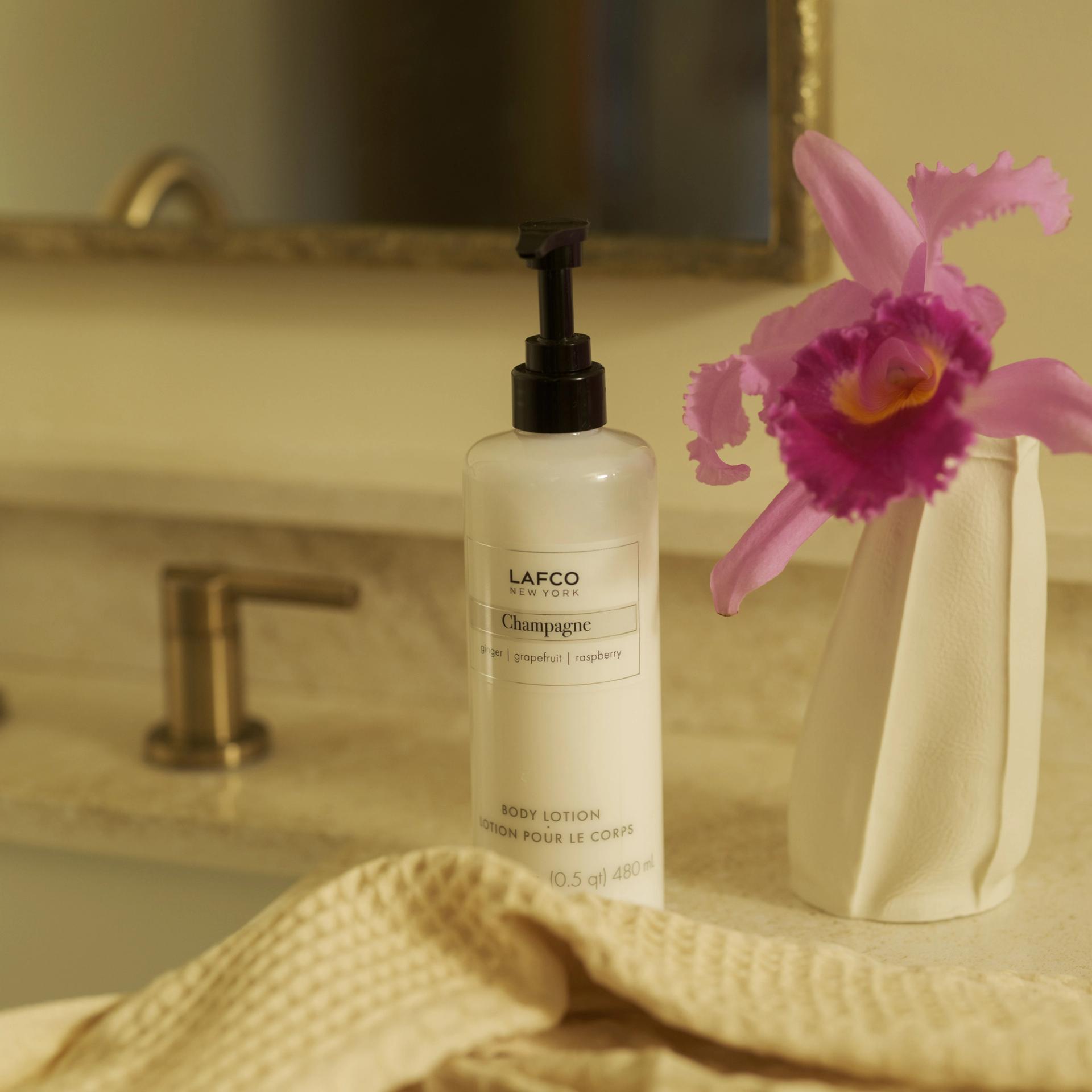 Lafco Champagne Body Lotion on bathroom countertop