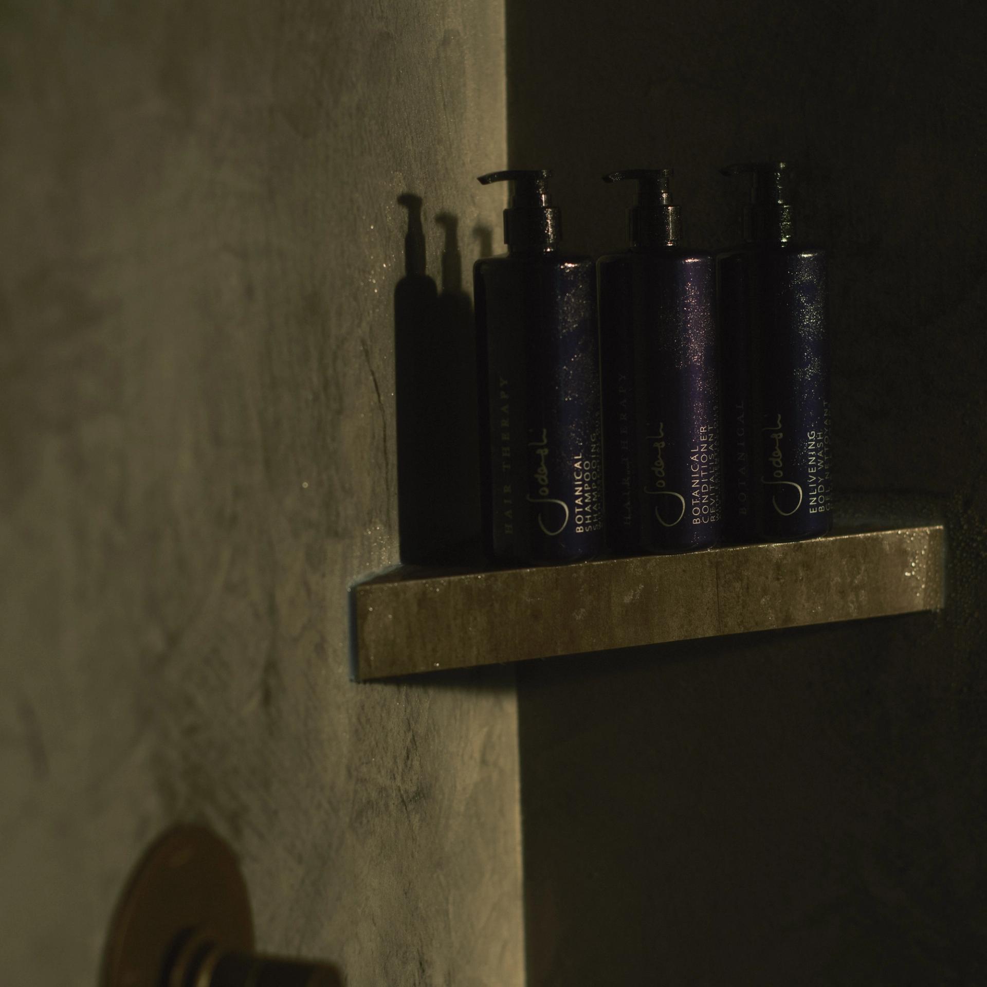 Sodashi Shampoo, Conditioner, and Body Wash dispensers on shower shelf