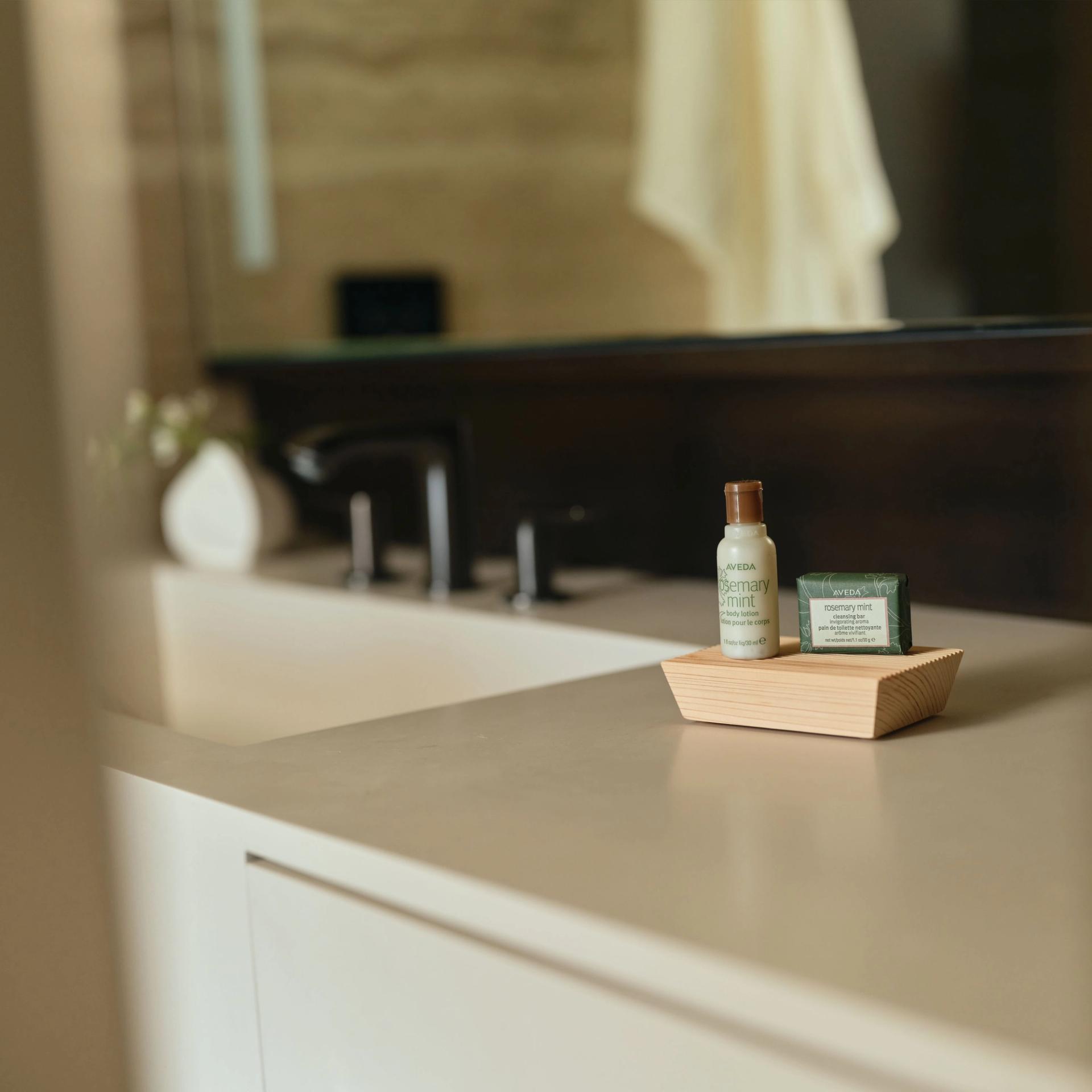 Aveda mini Body Lotion and Soap Bar on vanity side.