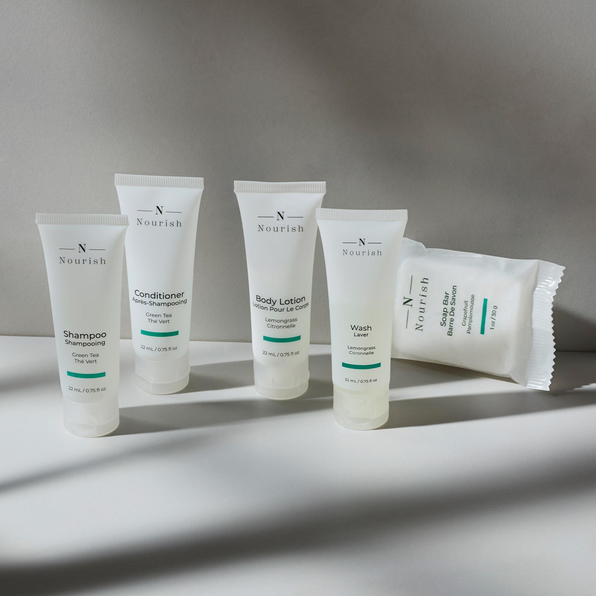 Nourish single-use shower amenities in tube packaging and bar soap