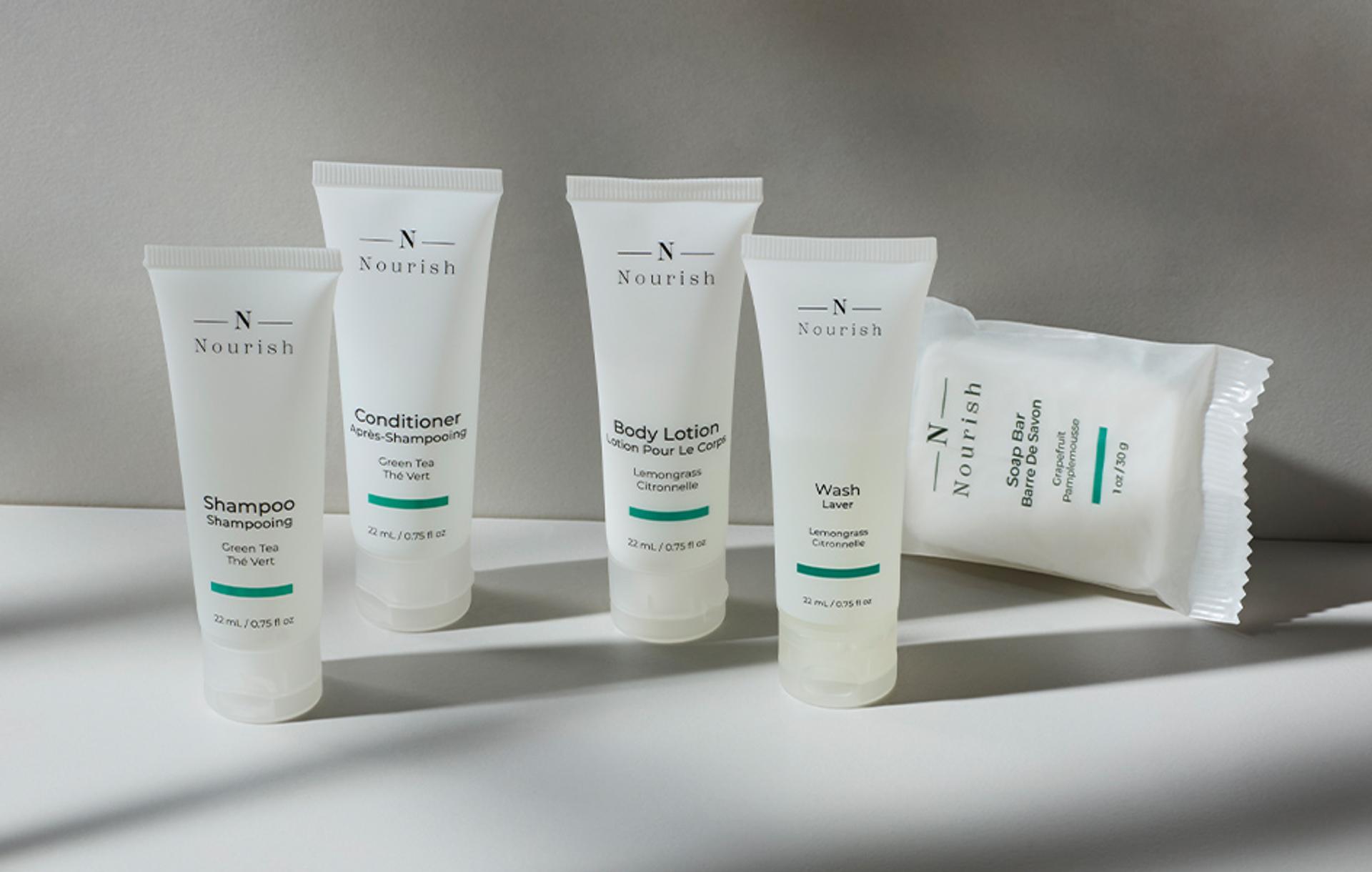 Nourish single-use shower amenities in tube packaging and bar soap