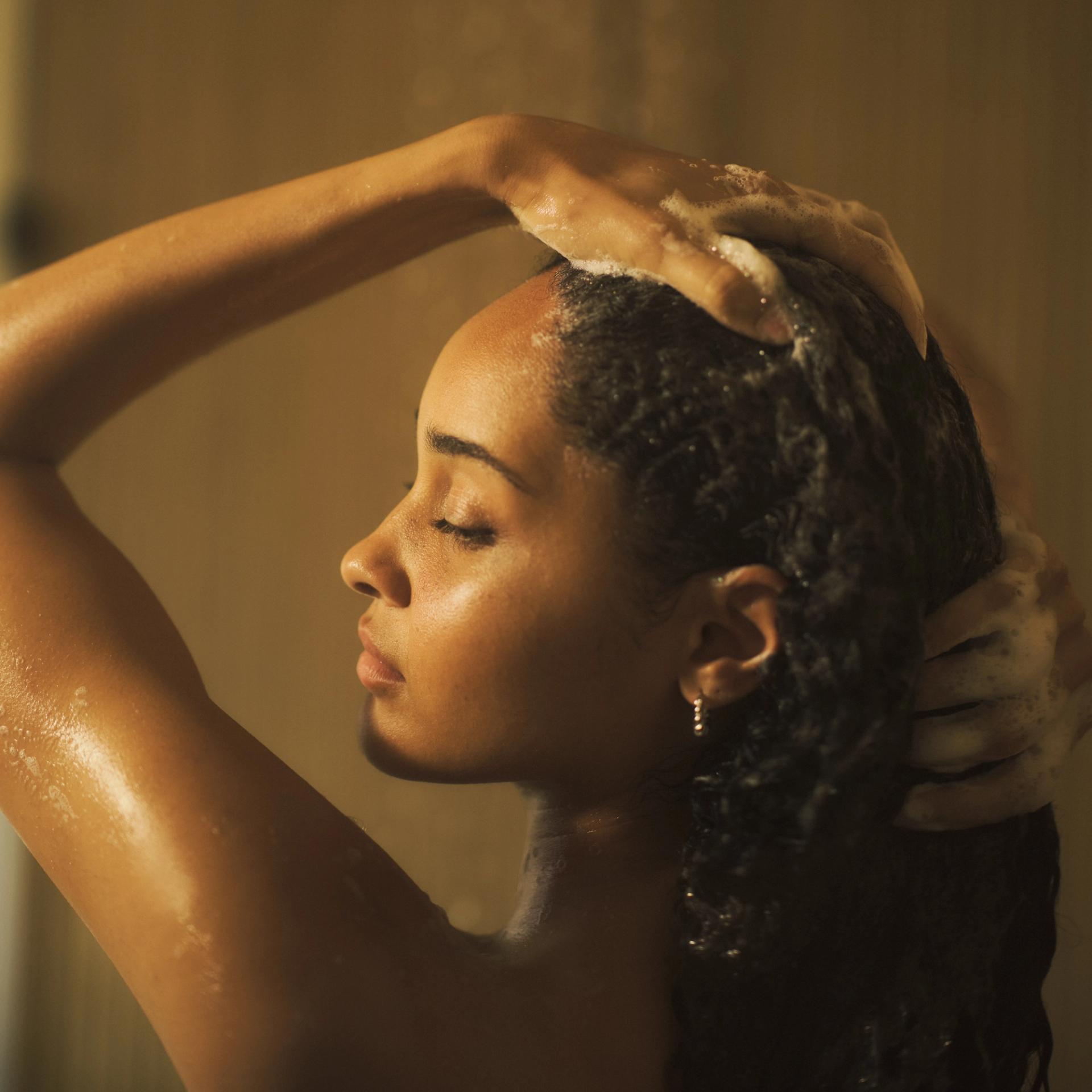 Girl in shower lathering hair
