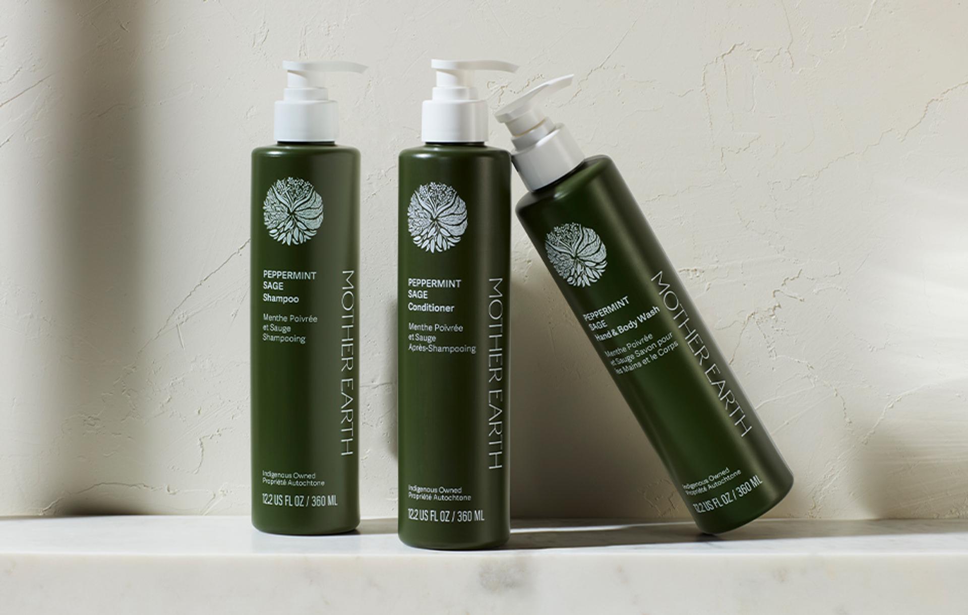 Mother Earth Essentials Peppermint Sage Shampoo, Conditioner and Body Wash dispensers on counter