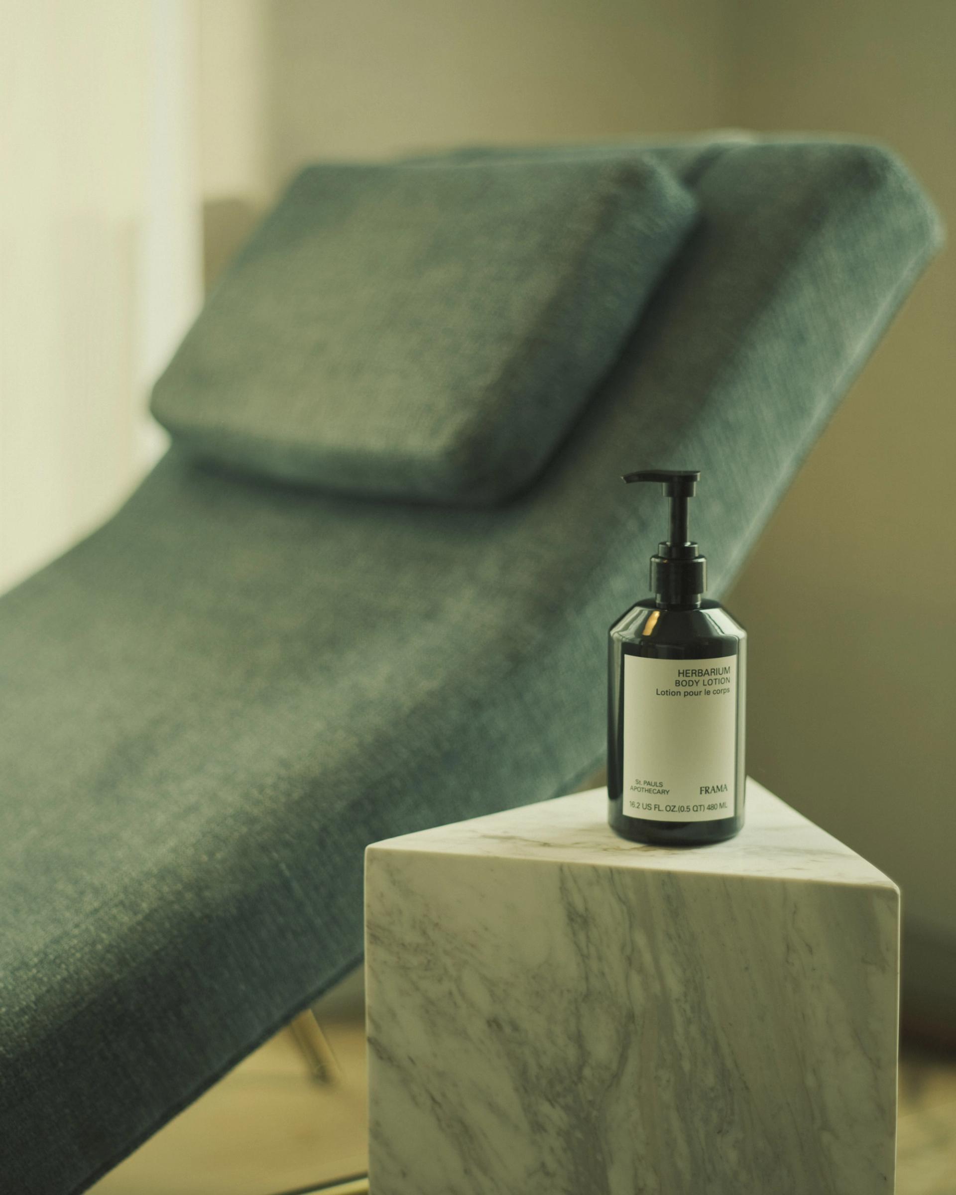 Frama Herbarium Lotion on side table in hotel room
